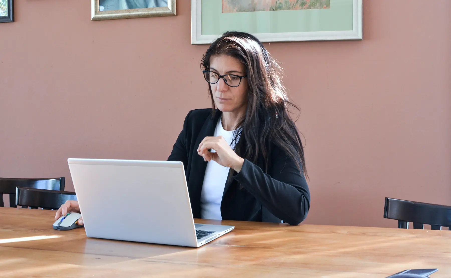 A hiring manager reviewing candidates on a laptop